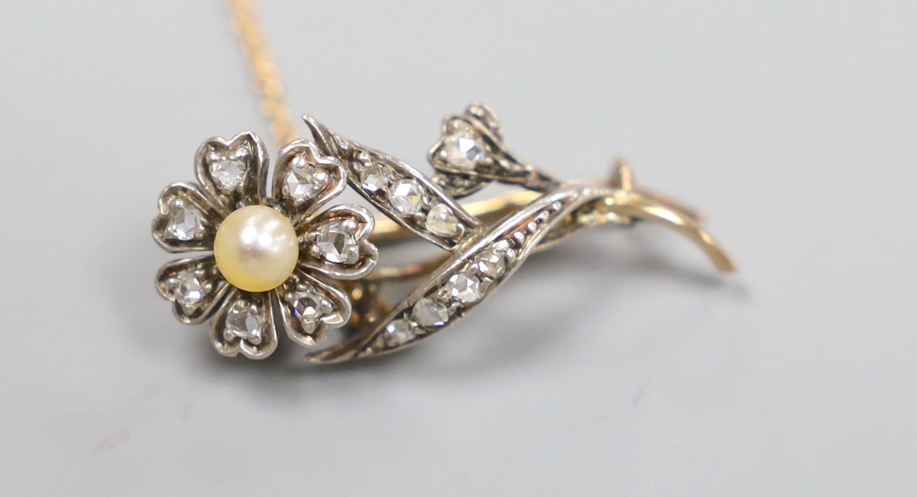 A Victorian yellow metal, pearl and rose cut diamond set flower brooch, 31mm, gross 3.6 grams.